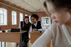 students in the classroom whispering