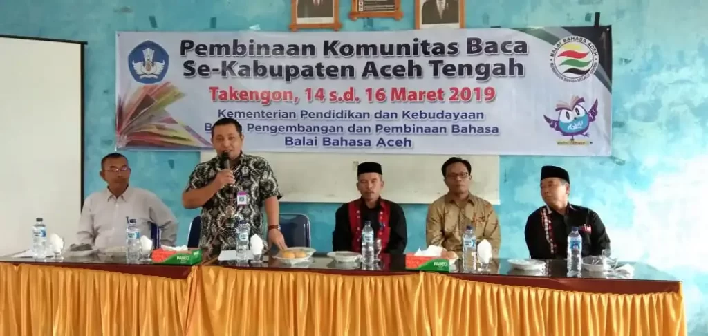 Murhaban, S.Ag., M.A. menyampaikan laporan panitia pada pembukaan Pembinaan Komunitas Baca Se-Kabupaten Aceh Tengah (14/3/2019) di Takengon